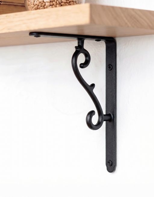 The 18 x 14.5cm Scroll Effect Wall Bracket Mounted on a White Coloured Modern Wall - Digital Illustration 