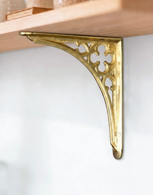 The 18 x 18cm Polished Brass Coalbrookdale Shelf Bracket Mounted on a Wooden Shelf In a Modern Home - Digital Illustration 