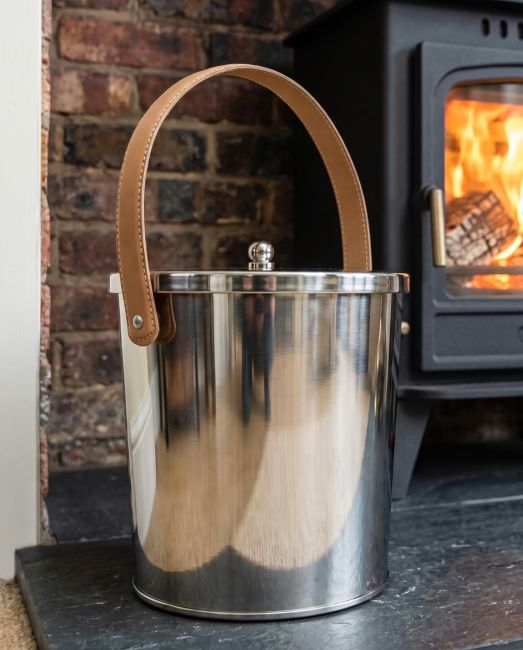 The 20cm Modern Stainless Steel Ash Bucket with Leather Strap Positioned To the Side of a Fireplace in a Modern Home - Digital Illustration The 20cm Modern Stainless Steel Ash Bucket with Leather Strap Positioned To the Side of a Fireplace in a Modern Home - Digital Illustration