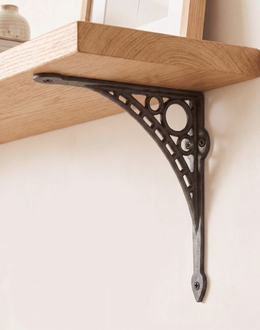 The 20cm x 22cm "Iron Bridge" Shelf Bracket Mounted on a Cream Coloured Living Room Wall - Digital Illustration