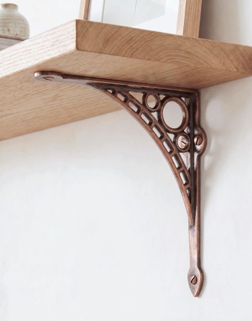 The 20cm x 22cm Antique Copper Finish "Iron Bridge" Shelf Bracket Mounted on a Contemporary Living Room Wall - Digital Illustration