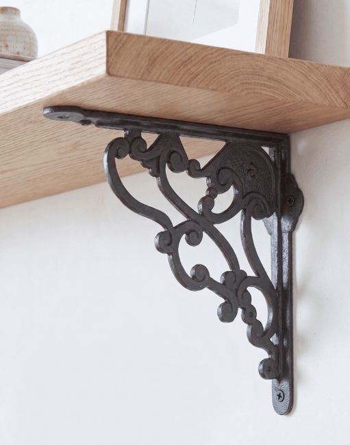 The 21 x 19cm "Tolousian" Art Nouveau Iron Shelf Bracket Mounted on a Contemporary Living Room Wall - Digital Illustration