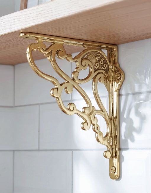 The 21cm x 19cm Art Nouveau Brass Shelf Bracket Mounted on a White Tiled Kitchen Wall - Digital Illustration
