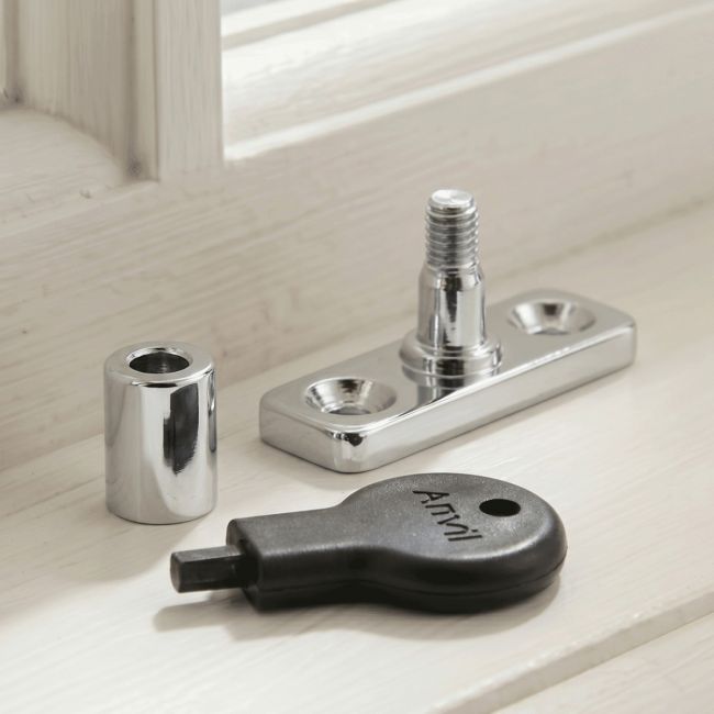 The "Abberwick" Bright Chrome Locking Stay Pin Placed in Front of a White Window in a Country Home - Digital Illustration 