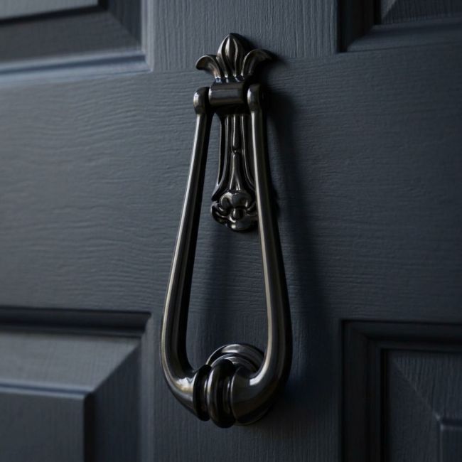 The "Addison Loop" Door Knocker in a Black Finish Shown on a White Door close up - Digital Illustration The "Addison Loop" Door Knocker in a Black Finish Shown on a White Door close up - Digital Illustration