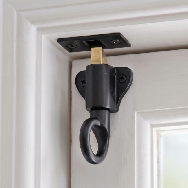 The "Aston" Black Iron Fanlight Catch with Two Keeps Mounted on a Wooden Door and Door Frame - Digital Illustration
