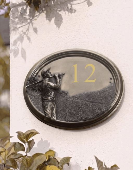 A Number 2 "Birkdale Park" Golfer House Number Sign in a Bronze Finish Mounted on a Cream Coloured Cottage Wall - Digital Illustration A Number 2 "Birkdale Park" Golfer House Number Sign in a Bronze Finish Mounted on a Cream Coloured Cottage Wall - Digital Illustration