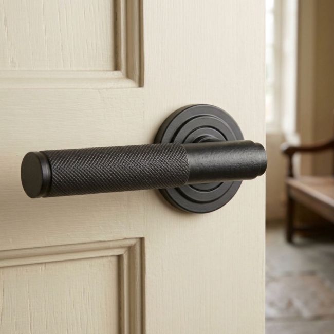 Matte Black Textured Unsprung Lever Door Handle on Art Deco Rose Front