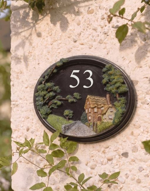 A Number 52 "Brushford Hill Cottage" Hand Painted Countryside House Sign Mounted on a Sunny Cream Coloured Cottage - Digital Illustration A Number 52 "Brushford Hill Cottage" Hand Painted Countryside House Sign Mounted on a Sunny Cream Coloured Cottage - Digital Illustration