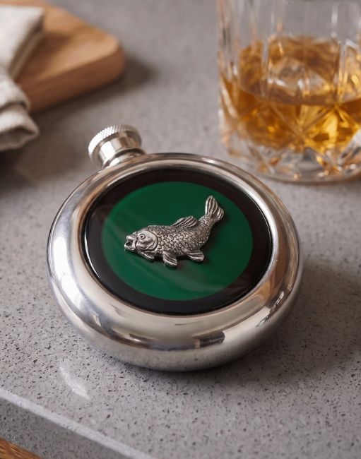 The "Cape Cod" stainless steel Hip Flask on a Grey Countertop with a Glass of Whiskey next to it - Digital Illustration