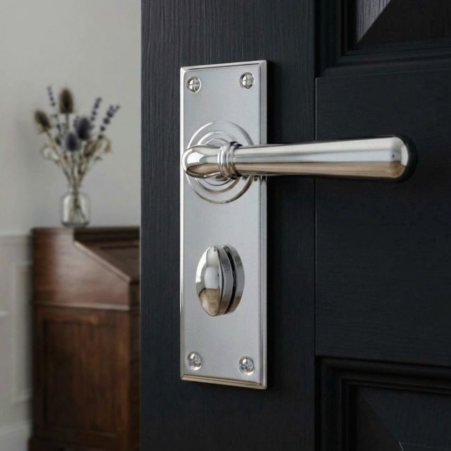 The "Emerson" Bright Chrome Lever Door Handles With Bathroom Lock on an Ensuite Bathroom Door - Digital Illustration