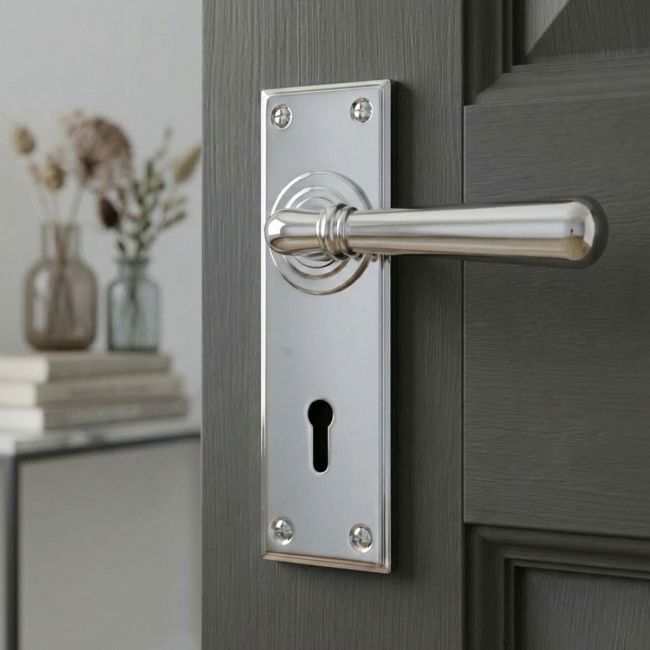 The "Emerson" Bright Chrome Lever Handle Set With Keyhole on a Modern Grey Door in a Country Home - Digital Illustration