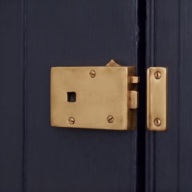 The "Fitzroy" Brass Rim Latch with Draw Bolt for a Left Hand Door Mounted on a Wooden Front Door - Digital Illustration