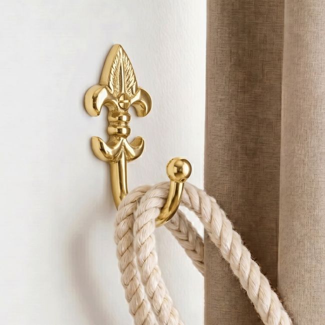 The "Fleur De Ly’s" Curtain Tie Back Fitted on a Modern White Interior Wall Next to a Brown Curtain - Digital Illustration The "Fleur De Ly’s" Curtain Tie Back Fitted on a Modern White Interior Wall Next to a Brown Curtain - Digital Illustration