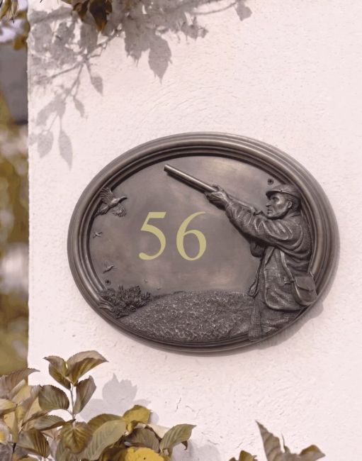 A Number 60 "Game & Grouse" House Number Sign in a Bronze Finish Mounted on a Cream Coloured Cottage Wall - Digital Illustration