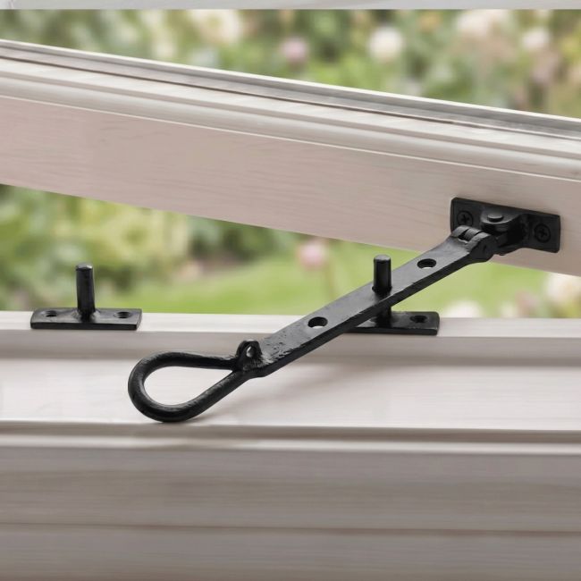 The "Hartlake Park" Cast Iron Window Stay Fitted on a White Open Window Frame - Digital Illustration The "Hartlake Park" Cast Iron Window Stay Fitted on a White Open Window Frame - Digital Illustration