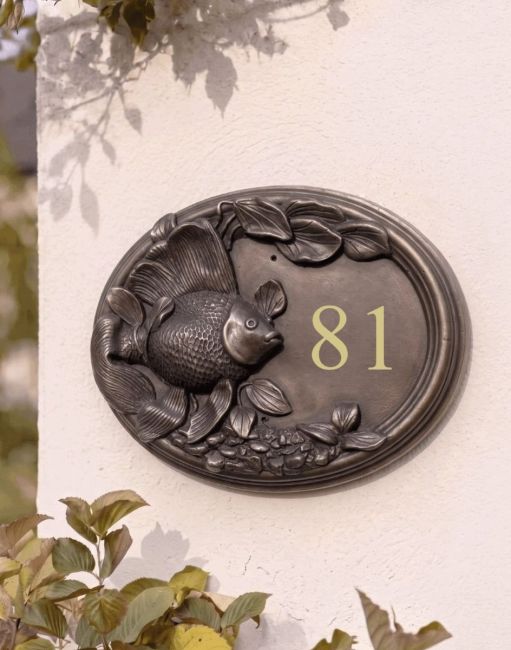 A Number 20 "Highcote Waters" Goldfish House Sign Mounted on a Sunny House Exterior Wall - Digital Illustration