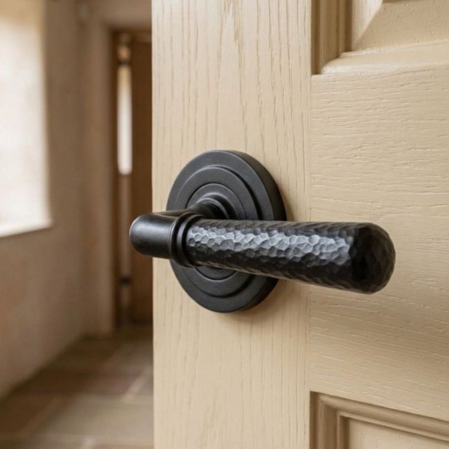 Matte Black Hammered Unsprung Lever Door Handle on Art Deco Rose