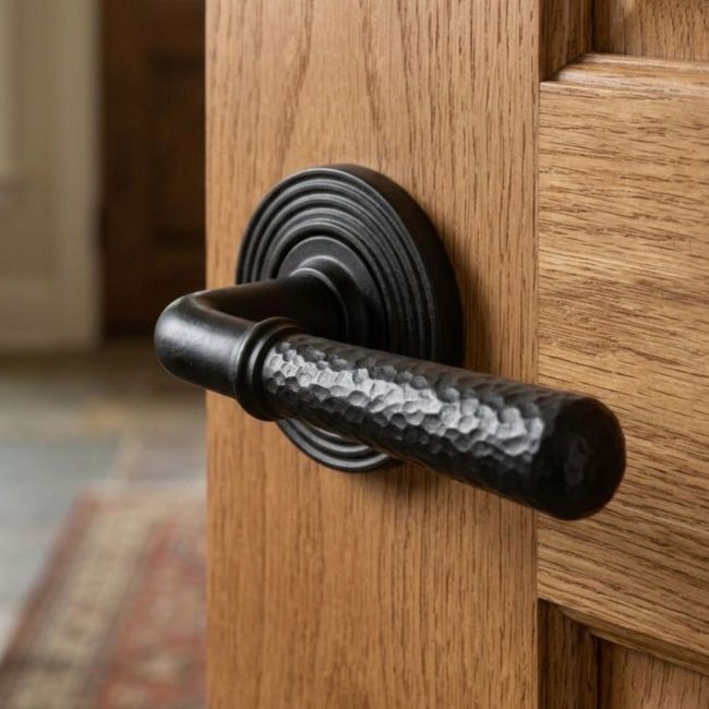 Matte Black Hammered Unsprung Lever Door Handle on Beehive Rose Front