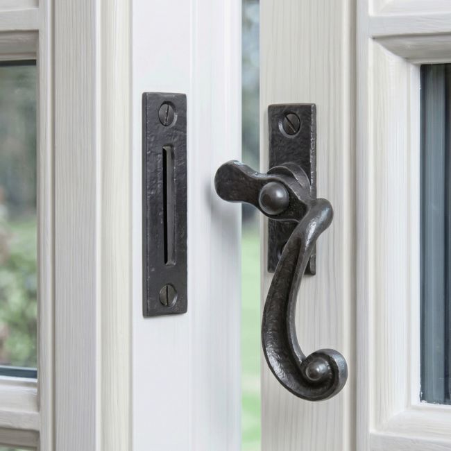 The "Melbridge" Scrolled Black Iron Window Fastener Displayed Fitted on an Open White Window Frame - Digital Illustration The "Melbridge" Scrolled Black Iron Window Fastener Displayed Fitted on an Open White Window Frame - Digital Illustration