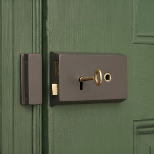 The "Penbrook" Cast Iron and Brass Rim Lock - Left or Right Hand Fitted on a Green Wooden Door - Digital Illustration 