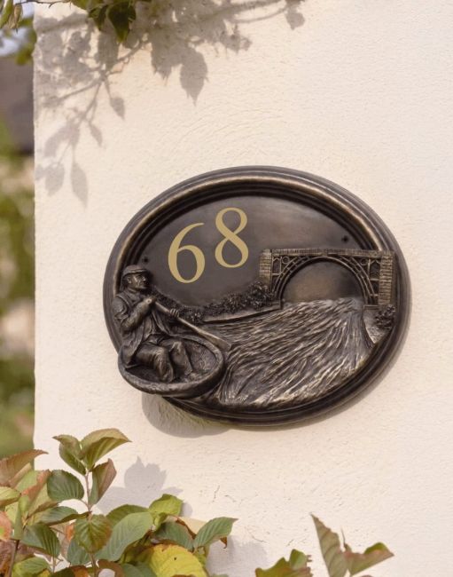 A Number 68 "Rivervalley Gorge" Coracle Sailor House Sign Mounted on a Cream Coloured Sunny Cottage Wall - Digital Illustration
