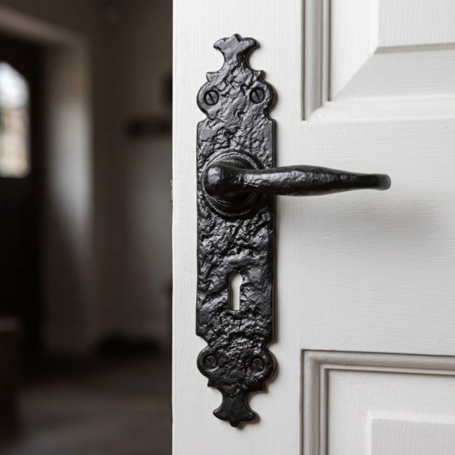 The "Shiredale" Antique Cast Iron Lever Handles with Key Hole on a White Wooden Door in a Traditional Home Hallway - Digital Illustration