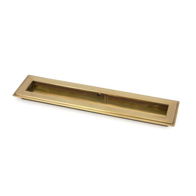 The 250mm Art Deco Rectangular Flush Pull Handle in Aged Brass Shown at an Angle on a White Background