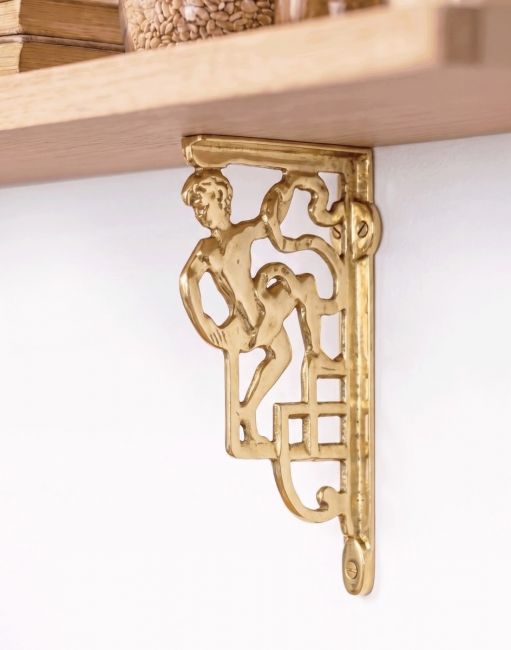 The 25 x 12cm Polished Brass Roman Man Design Bracket Mounted on a Cream Coloured Living Room Wall - Digital Illustration 