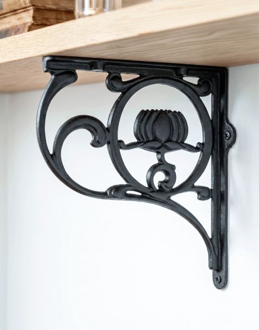 The 25 x 23cm Black "Lotus Flower" Shelf Bracket Mounted in a Contemporary Kitchen on a White Wall - Digital Illustration 