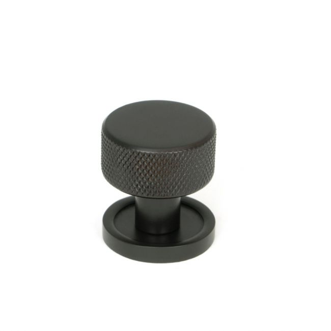 The 25mm Knurled Cabinet Knob on a Plain Rose in Aged Bronze Shown Upright on a White Background 