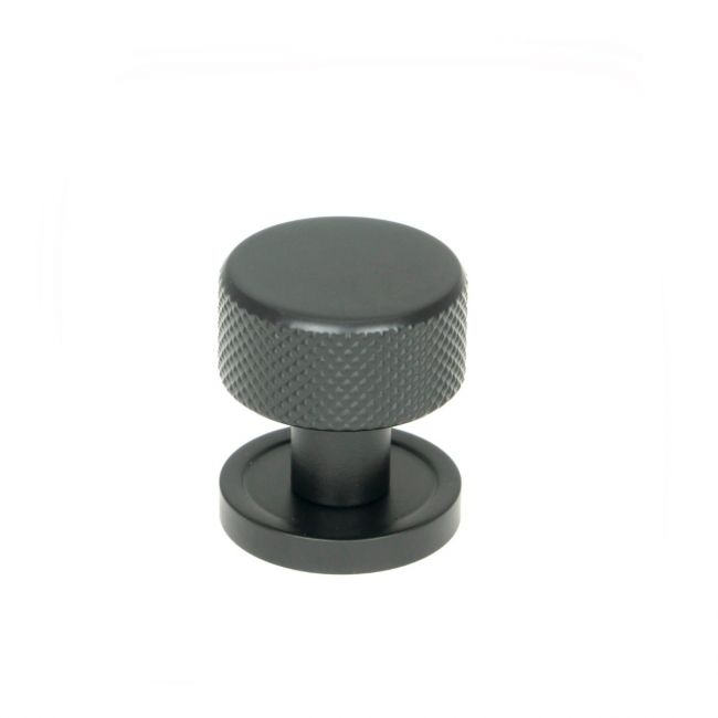 The 25mm Knurled Cabinet Knob on a Plain Rose in Matt Black Shown Upright on a White Background 