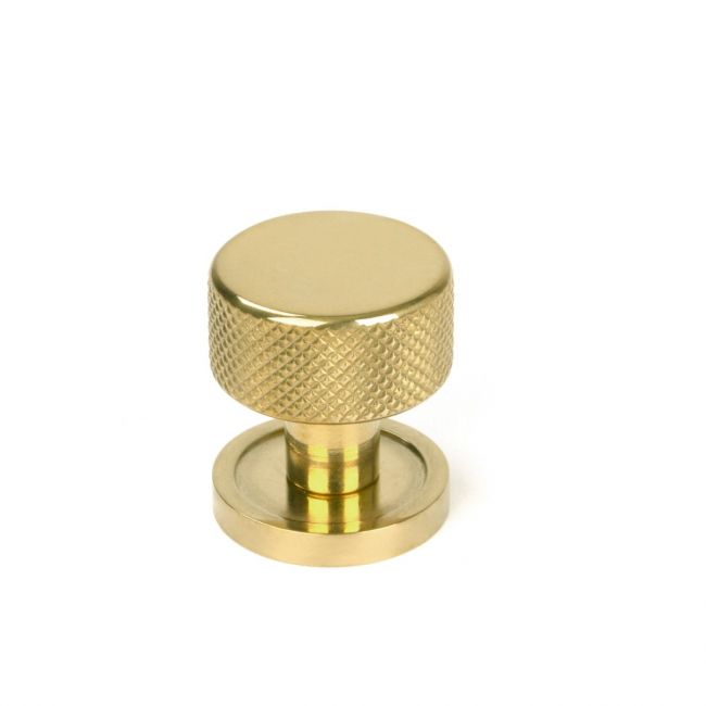 The 25mm Knurled Cabinet Knob on a Plain Rose in Polished Brass Shown Upright on a White Background The 25mm Knurled Cabinet Knob on a Plain Rose in Polished Brass Shown Upright on a White Background