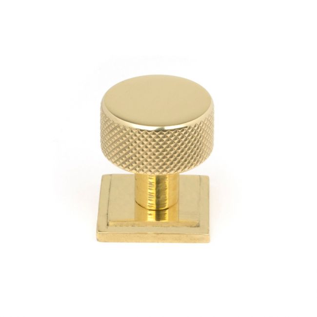 The 25mm Knurled Cabinet Knob on a Square Rose in Polished Brass Shown Upright on a White Background The 25mm Knurled Cabinet Knob on a Square Rose in Polished Brass Shown Upright on a White Background