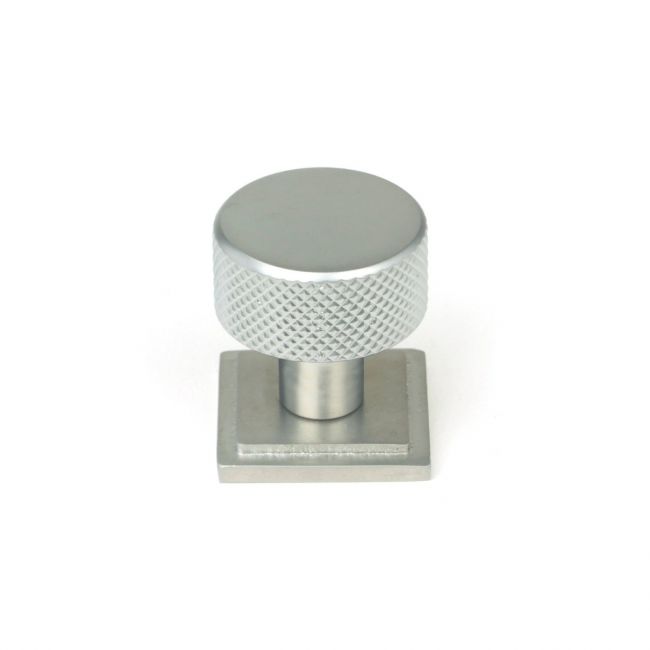 The 25mm Knurled Cabinet Knob on a Square Rose in Satin Chrome Shown Upright on a White Background