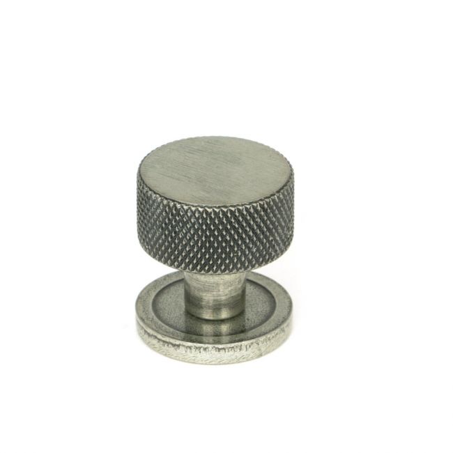 The 25mm Knurled Cabinet Knob on Plain Rose in Pewter Shown Upright on a White Background The 25mm Knurled Cabinet Knob on Plain Rose in Pewter Shown Upright on a White Background