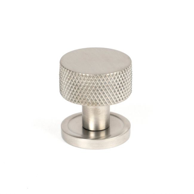 The 25mm Knurled Cabinet Knob on Plain Rose in Satin Stainless Steel Shown Upright on a White Background The 25mm Knurled Cabinet Knob on Plain Rose in Satin Stainless Steel Shown Upright on a White Background
