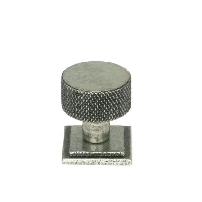 The 25mm Knurled Cabinet Knob on Square Rose in Pewter Shown Upright on a White Background The 25mm Knurled Cabinet Knob on Square Rose in Pewter Shown Upright on a White Background