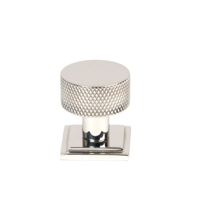 The 25mm Knurled Cabinet Knob on Square Rose in Polished Stainless Steel Shown Upright on a White Background The 25mm Knurled Cabinet Knob on Square Rose in Polished Stainless Steel Shown Upright on a White Background