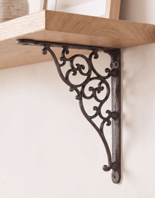 The 27.5cm x 20.5cm Cast Iron Ornate Scroll Shelf Bracket Mounted on a Cream Coloured Interior Home Wall - Digital Illustration 