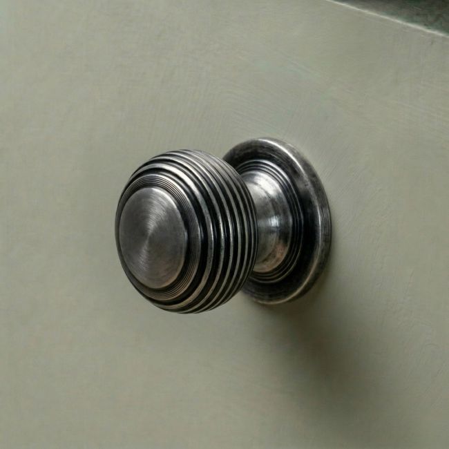 The 30mm "Garrison" Ribbed Beehive Knob in Pewter on a Whitebackground Shown from the Side The 30mm "Garrison" Ribbed Beehive Knob in Pewter on a Whitebackground Shown from the Side