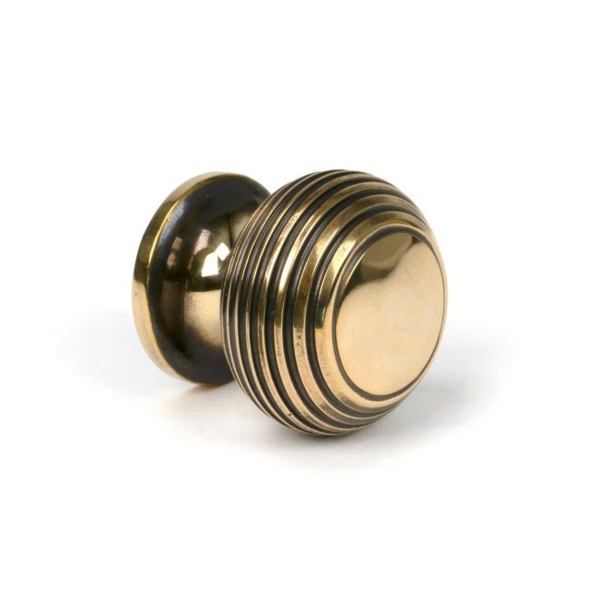 The 30mm Individual Aged Brass Beehive Cabinet Knob Viewed from the Side on a White Background