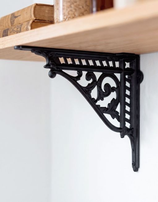 The 31 x 26cm Heritage Style Black Shelf Bracket Used as a DIY Shelf on a White Interior Wall - Digital Illustration