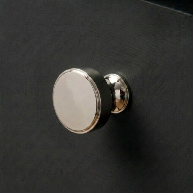 The 32mm "Atelier" Circular Cabinet Knob in Polished Nickel on a White Background Shown from Side on