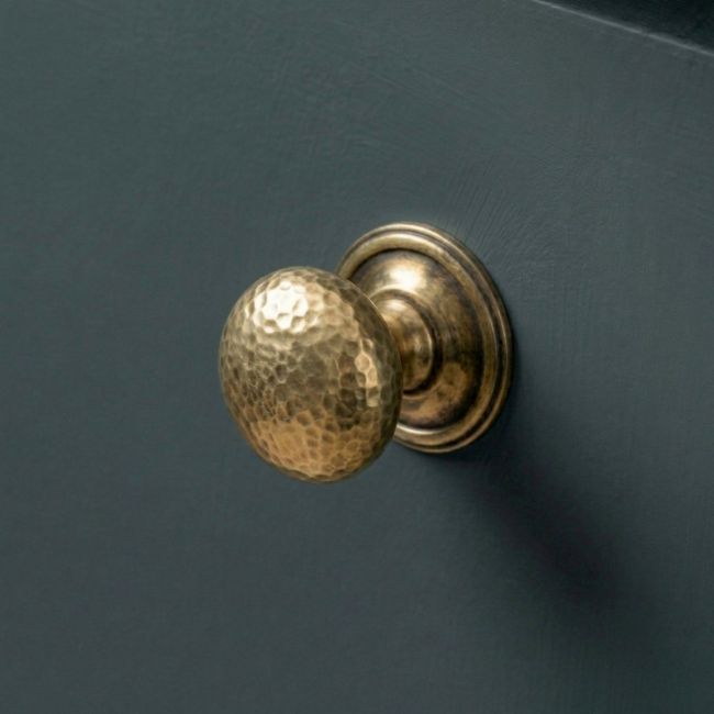 The 32mm Aged Brass Hammered Mushroom Cabinet Knob Mounted on a Blue Kitchen Cabinet - Digital Illustration 