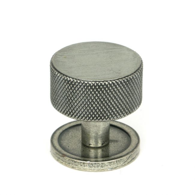 The 32mm Knurled Cabinet Knob on a Plain Rose in Pewter Shown Upright on a White Background The 32mm Knurled Cabinet Knob on a Plain Rose in Pewter Shown Upright on a White Background