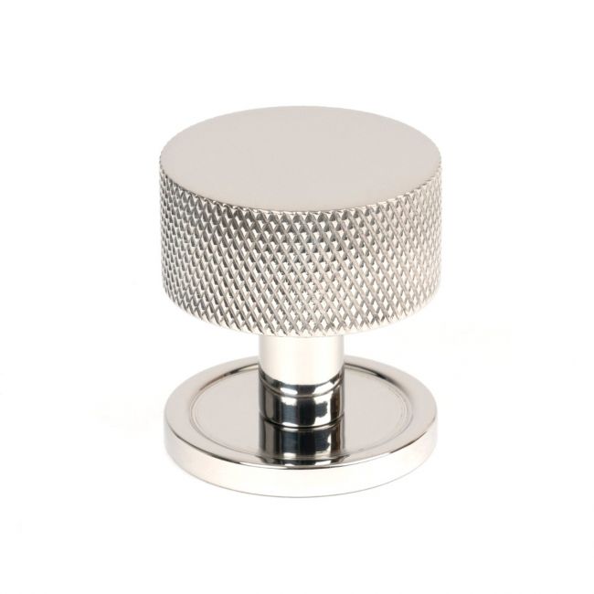 The 32mm Knurled Cabinet Knob on a Plain Rose in Polished Stainless Steel Shown Upright on a White Background
