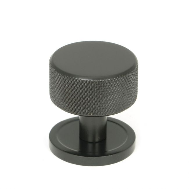 The 32mm Knurled Cabinet Knob on Plain Rose in Aged Bronze Shown Upright on a White Background