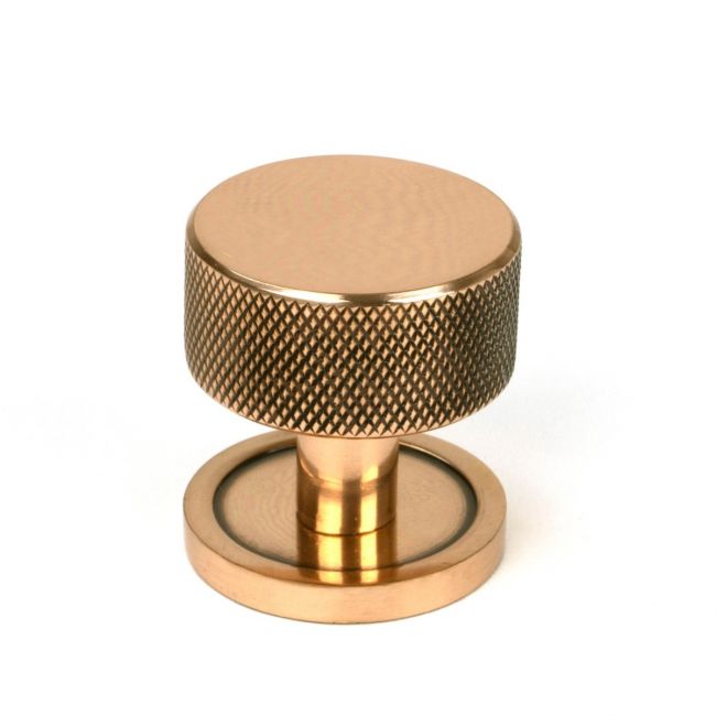 The 32mm Knurled Cabinet Knob on Plain Rose in Polished Bronze Shown Upright on a White Background The 32mm Knurled Cabinet Knob on Plain Rose in Polished Bronze Shown Upright on a White Background