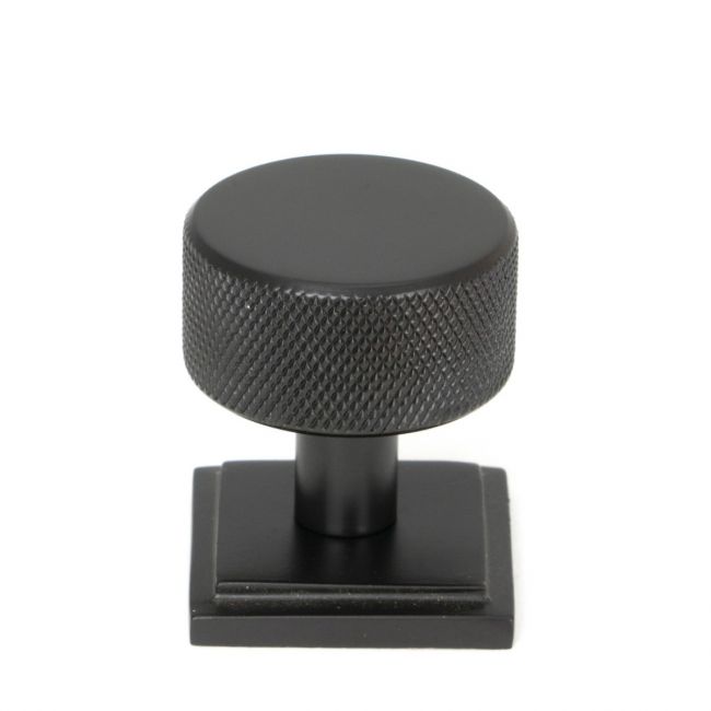 The 32mm Knurled Cabinet Knob on Square Rose in Aged Bronze Shown Upright on a White Background